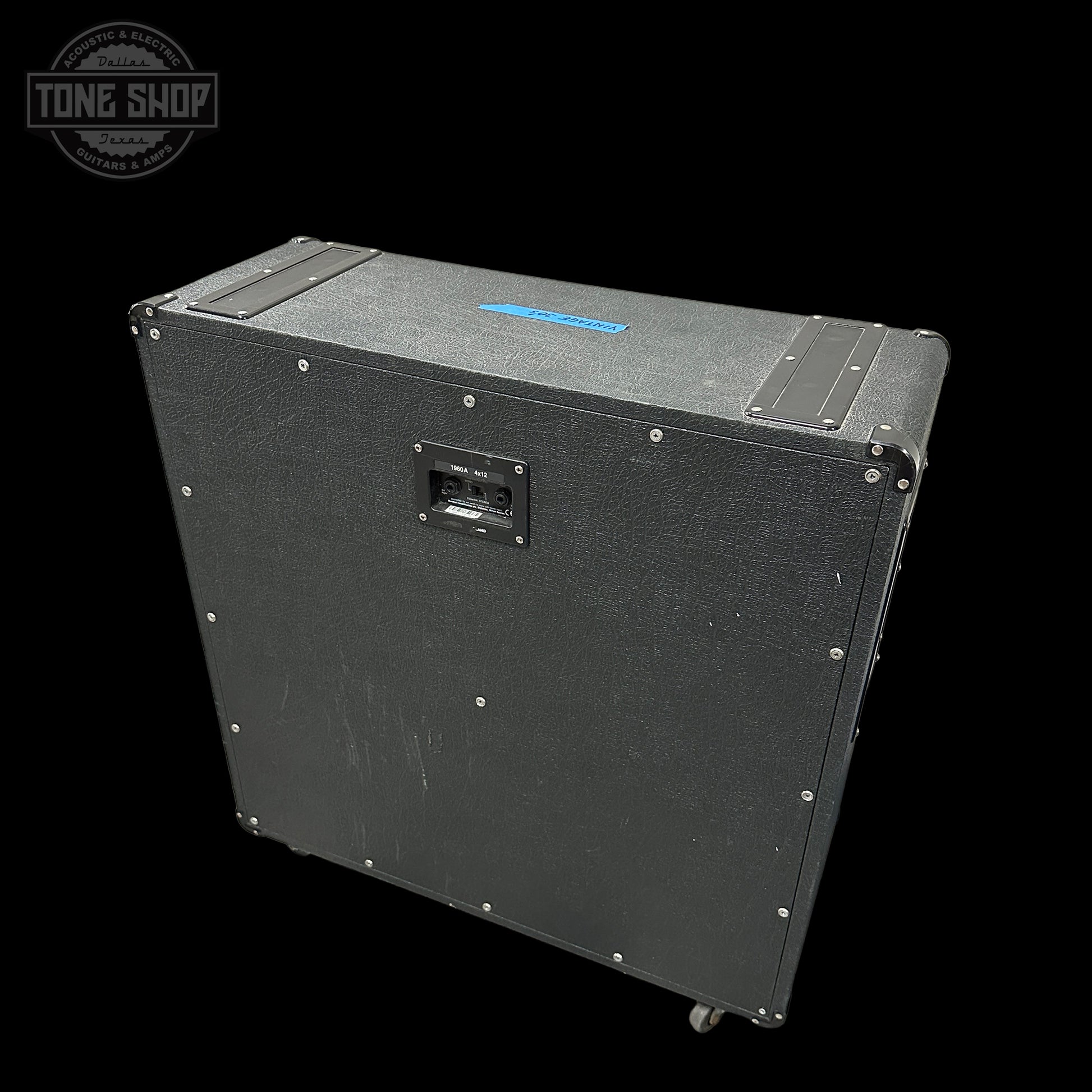 Black speaker cabinet with visible branding on a black background
