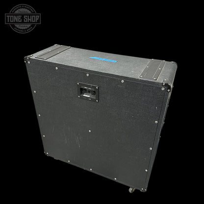 Black speaker cabinet with visible branding on a black background