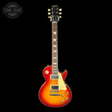 Electric guitar with a sunburst finish on a black background, featuring the Tone Shop logo.