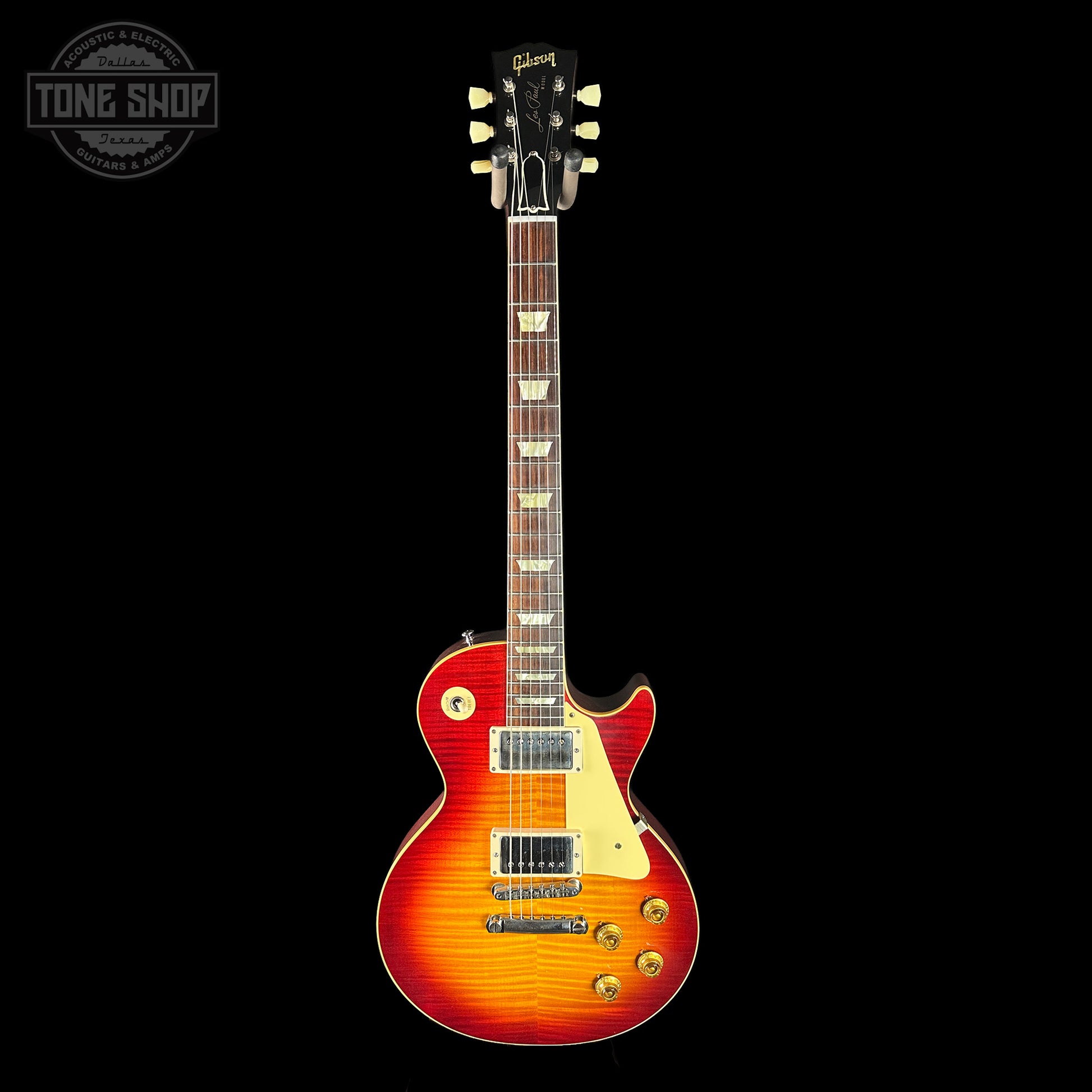 Electric guitar with a sunburst finish on a black background, featuring the Tone Shop logo.