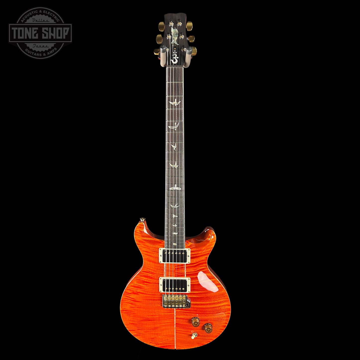 Orange electric guitar on a black background with 'Tone Shop' logo.