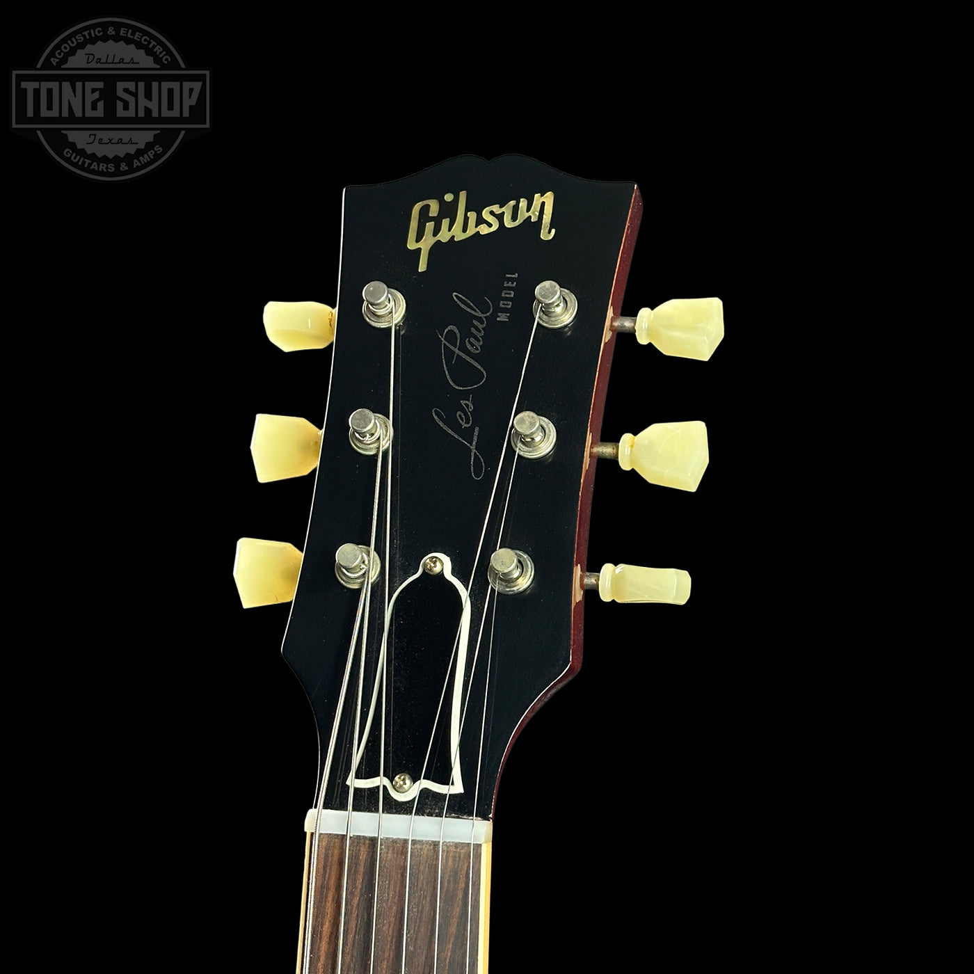 Gibson Les Paul guitar headstock with brand logo on a black background