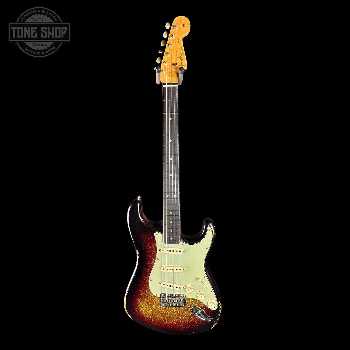 Electric guitar with a sunburst finish on a black background, featuring the Tone Shop logo.