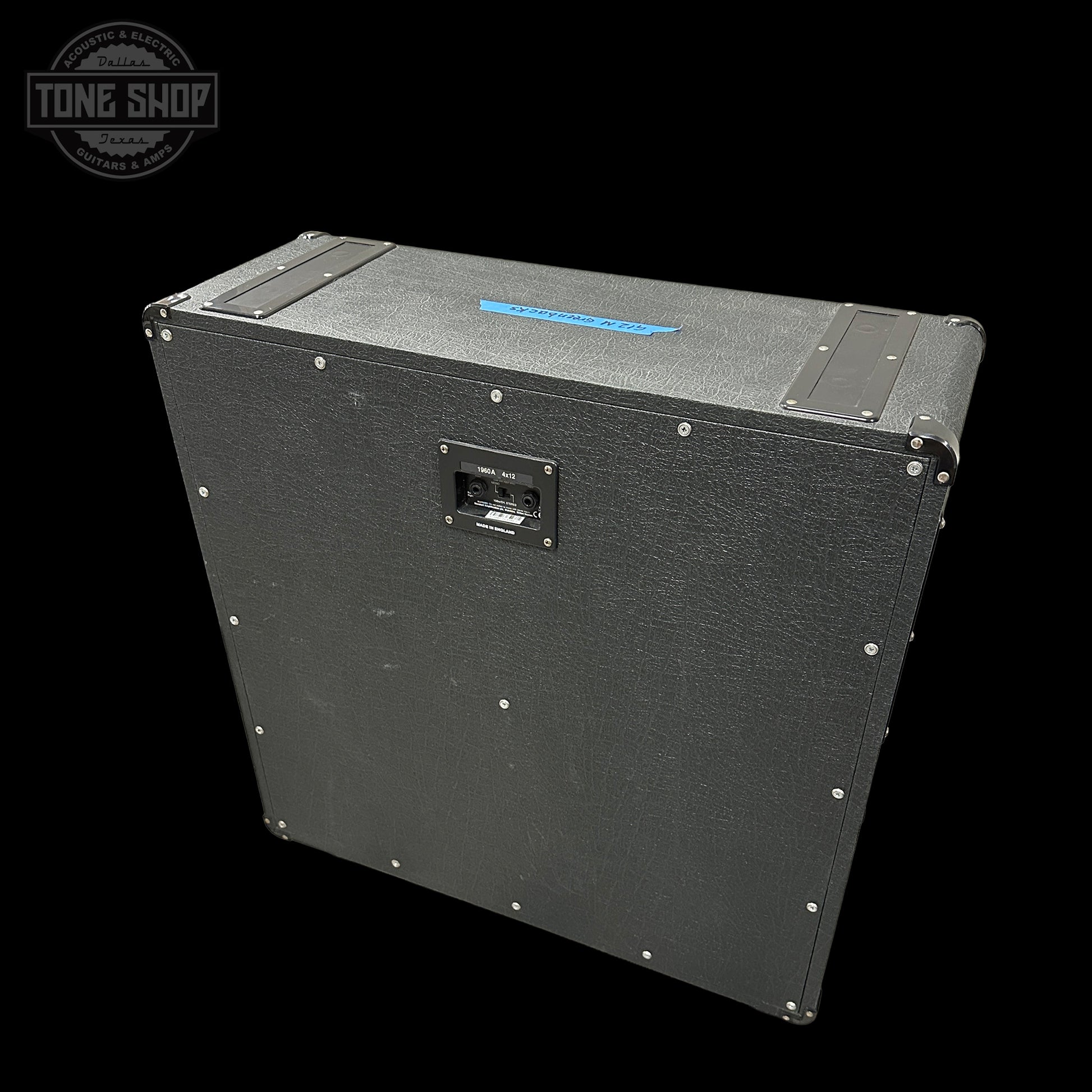 Black guitar amplifier cabinet with 'Tone Shop' logo in the corner