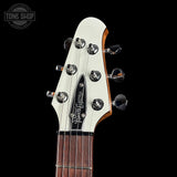 Guitar headstock with brand logo on a black background