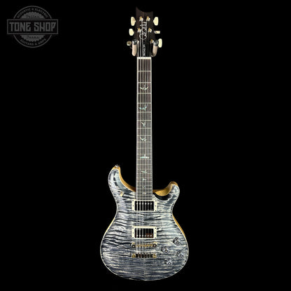 Electric guitar with a wavy wood finish on a black background, featuring the Tone Shop logo.