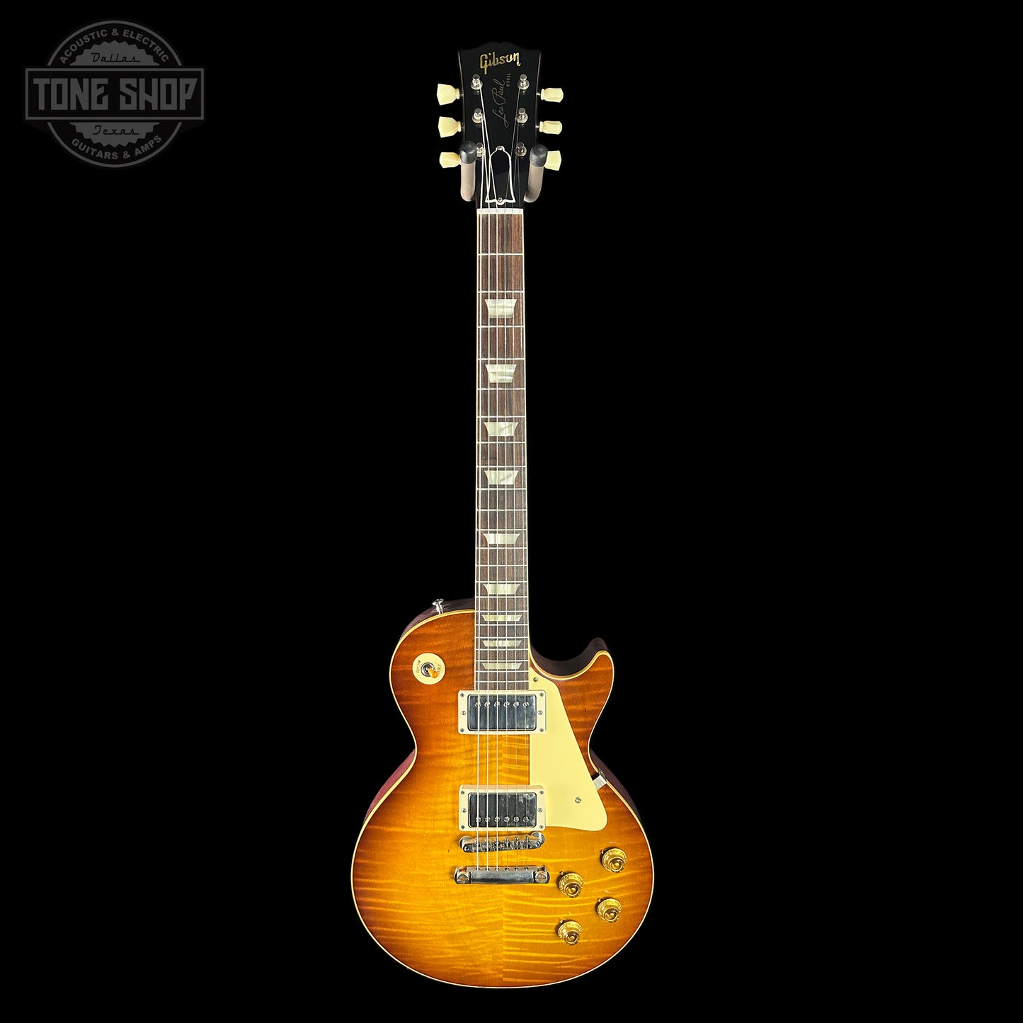 Electric guitar with a sunburst finish on a black background, featuring the Tone Shop logo.