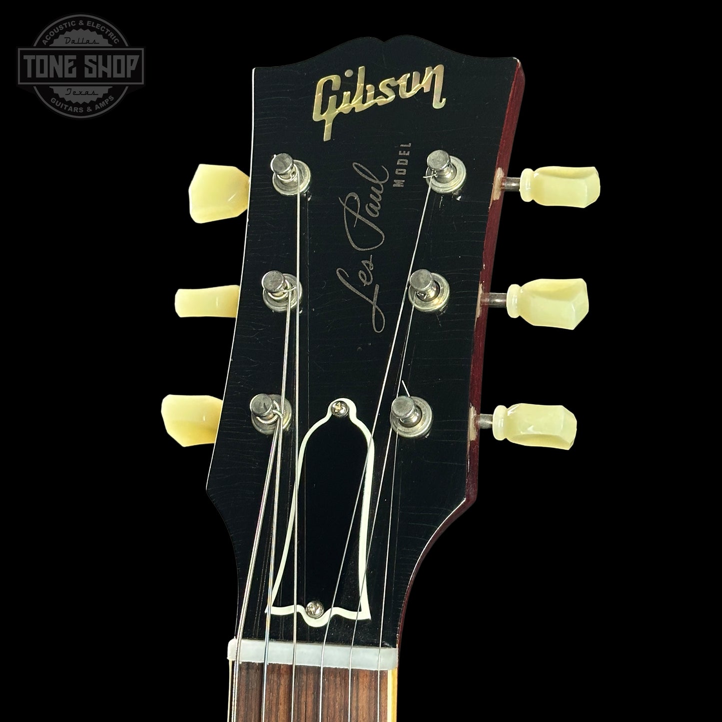 Gibson Les Paul guitar headstock with brand logo on a black background