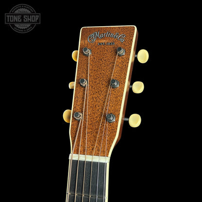 Close-up of a guitar headstock with 'Martin' branding on a black background