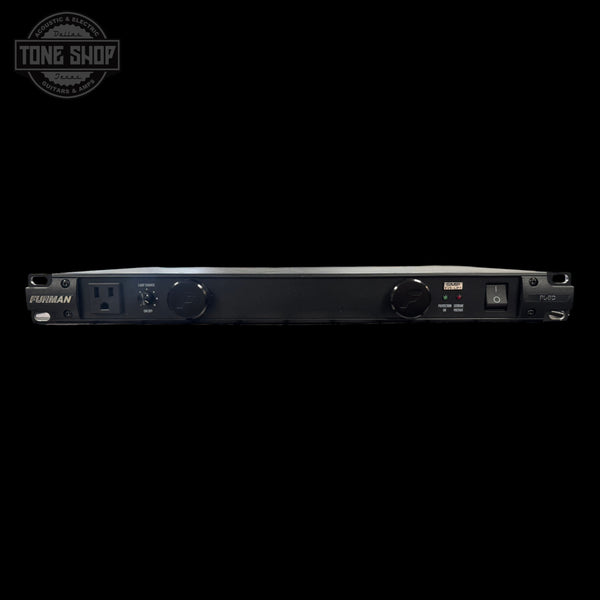 Black power conditioner with control knobs on a white background, featuring the Tone Shop logo.