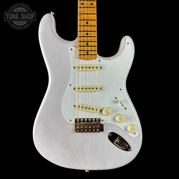 White electric guitar with a black background, featuring the Tone Shop logo.