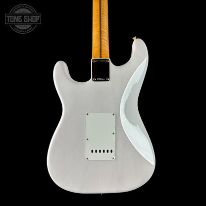 White electric guitar with a black pickguard on a white background