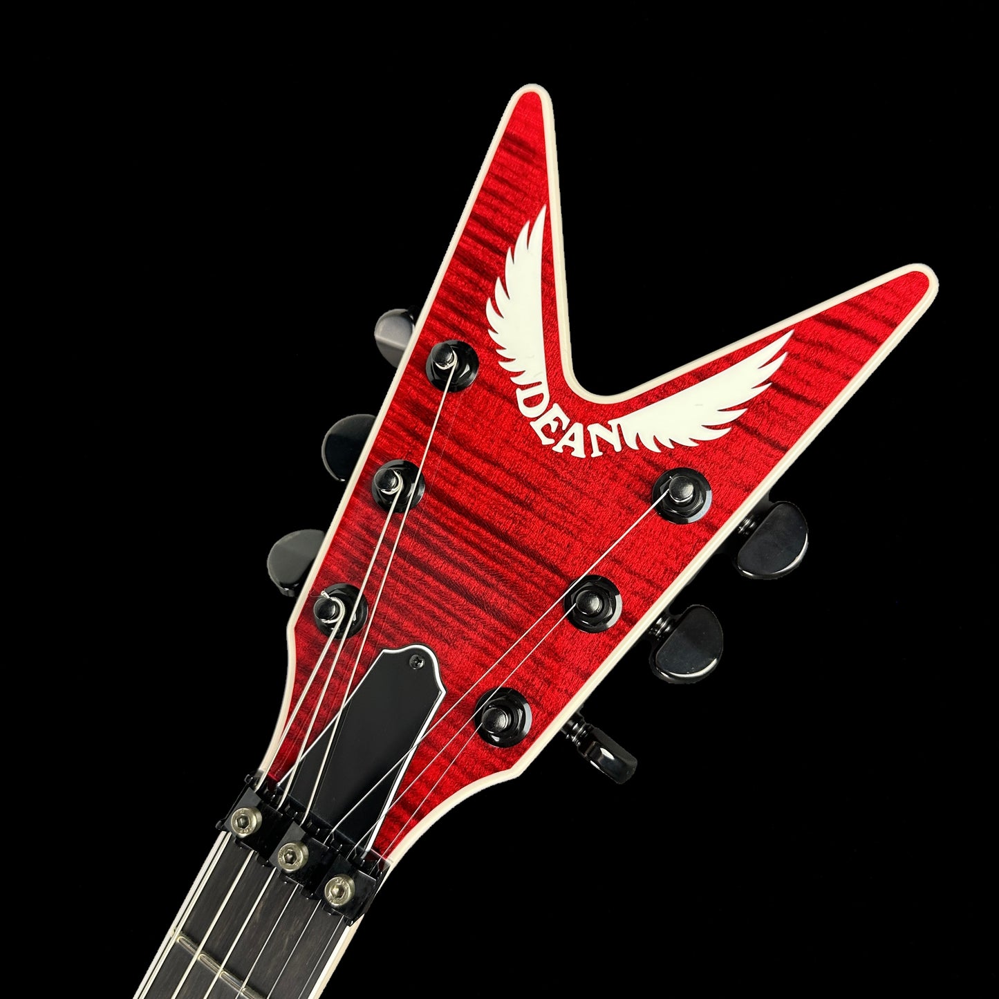 Front of headstock of Dean USA Dime Rebel Flame Top Trans Red.