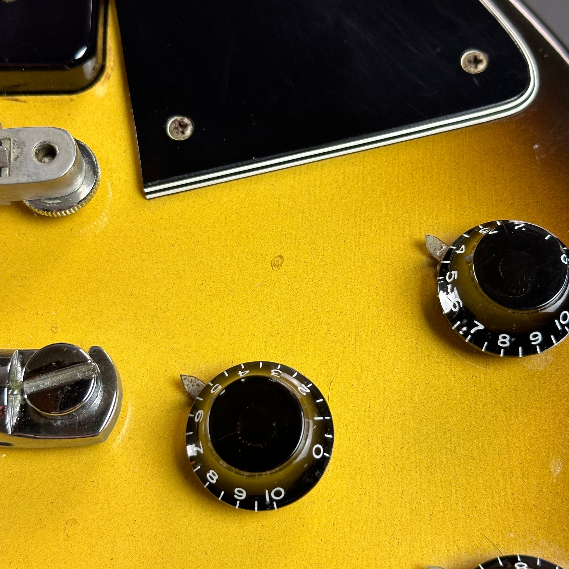 Small ding near pickguard of Used 1989 Gibson Les Paul Special Burst.