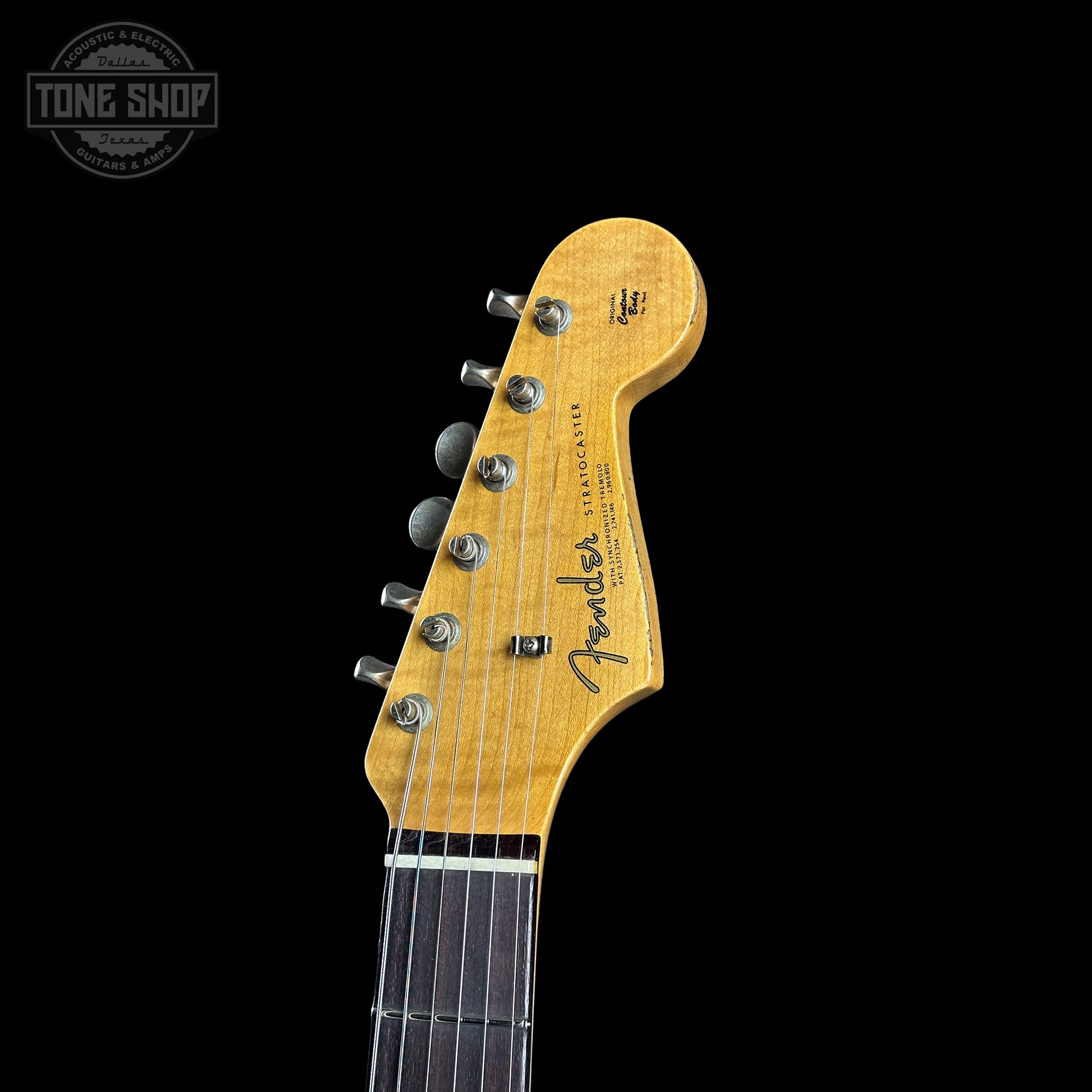 Fender guitar headstock on a black background with 'Tone Shop' logo.