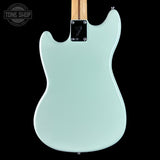 Light blue electric guitar body with Fender logo on a black background