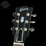Gibson guitar headstock with brand logo on a black background