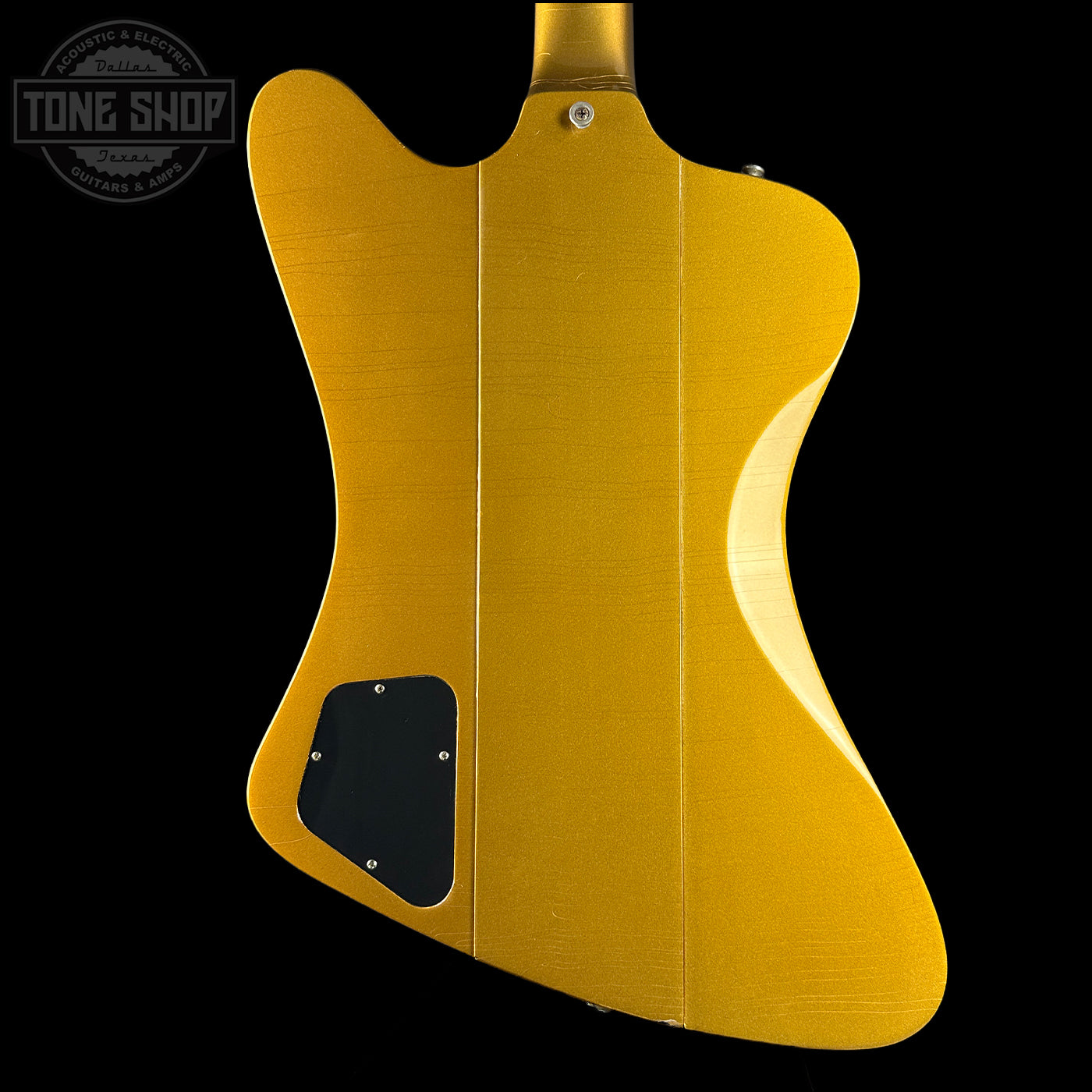 Gold electric guitar body with 'Tone Shop' logo in the corner