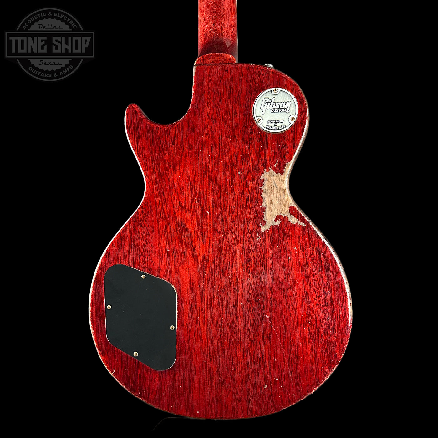 Red electric guitar with a visible brand logo on a black background