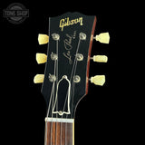 Gibson Les Paul guitar headstock with brand logo on a black background
