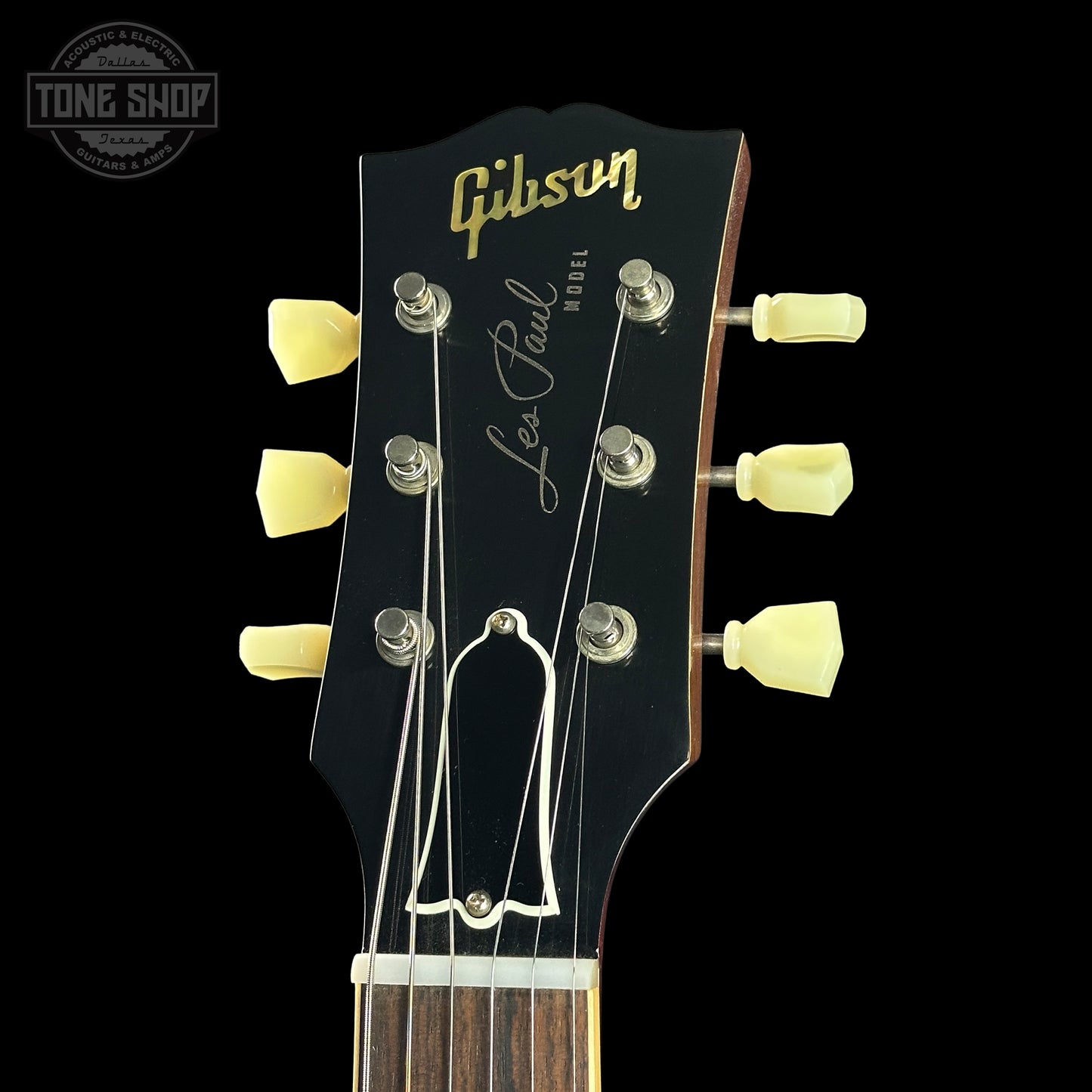 Gibson Les Paul guitar headstock with tuning pegs on a black background