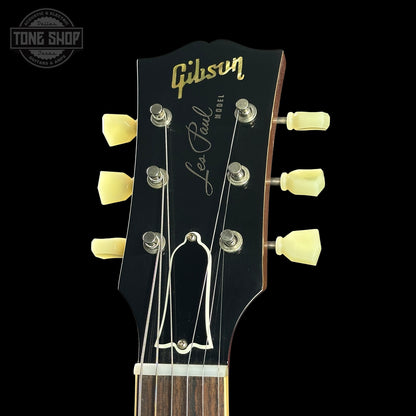 Gibson Les Paul guitar headstock with tuning pegs on a black background