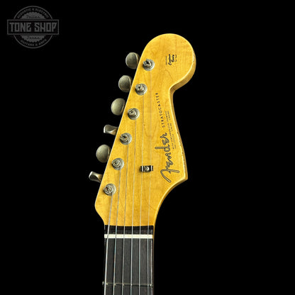 Guitar headstock with Fender logo on a black background