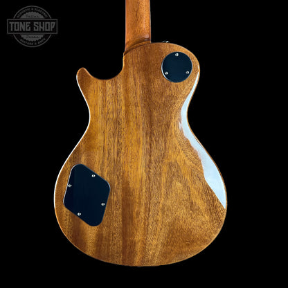 Close-up of a wooden guitar body with a 'Tone Shop' logo in the corner.