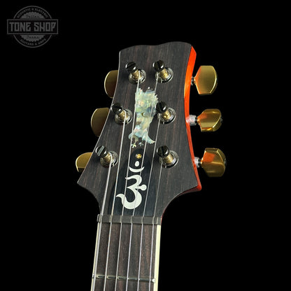 Guitar headstock with brand logo on a black background