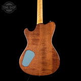 Back view of a wooden electric guitar with a visible brand logo in the corner.