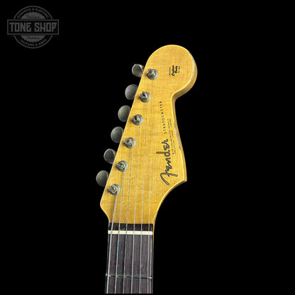 Close-up of a Fender guitar headstock on a black background