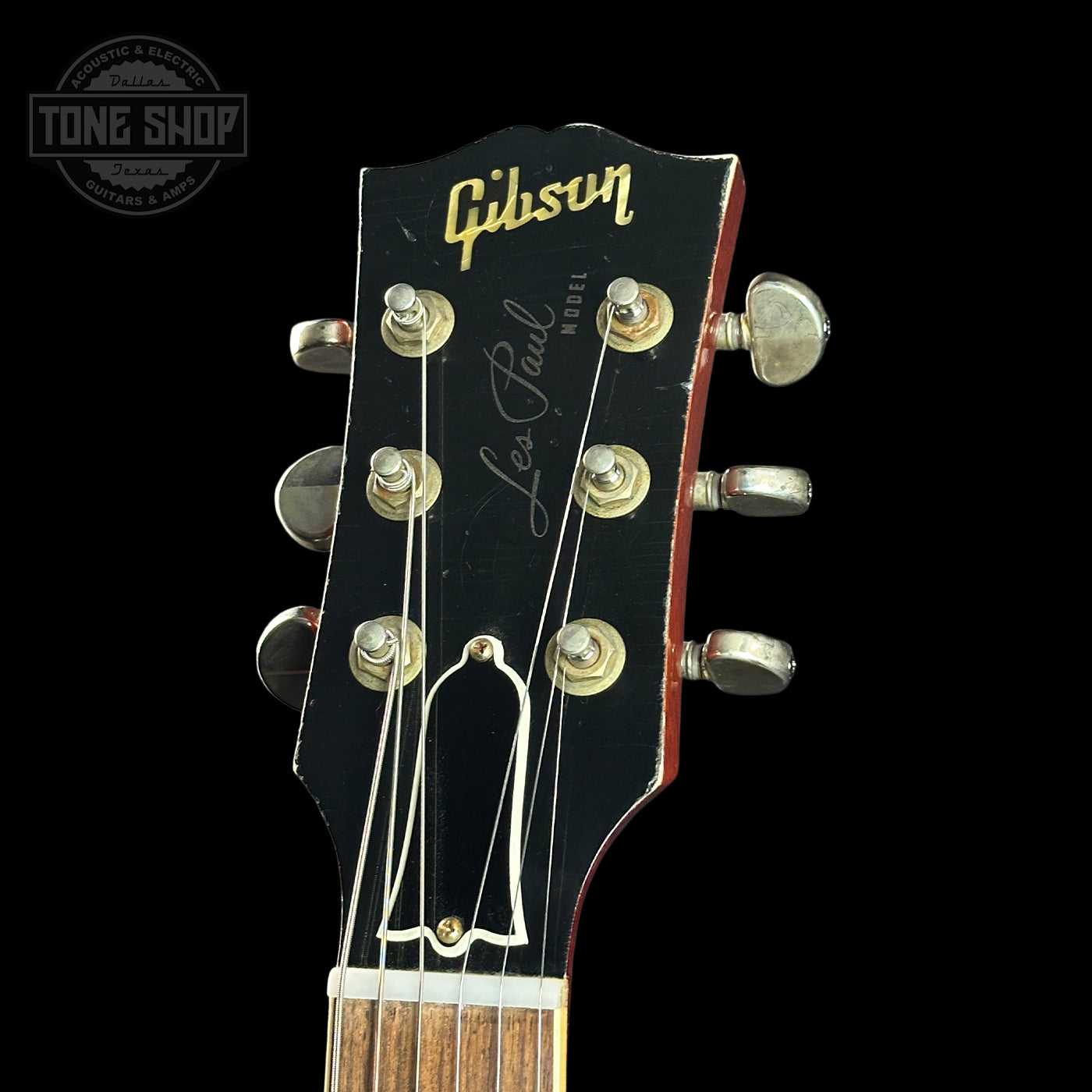 Gibson Les Paul guitar headstock with brand logo on a black background