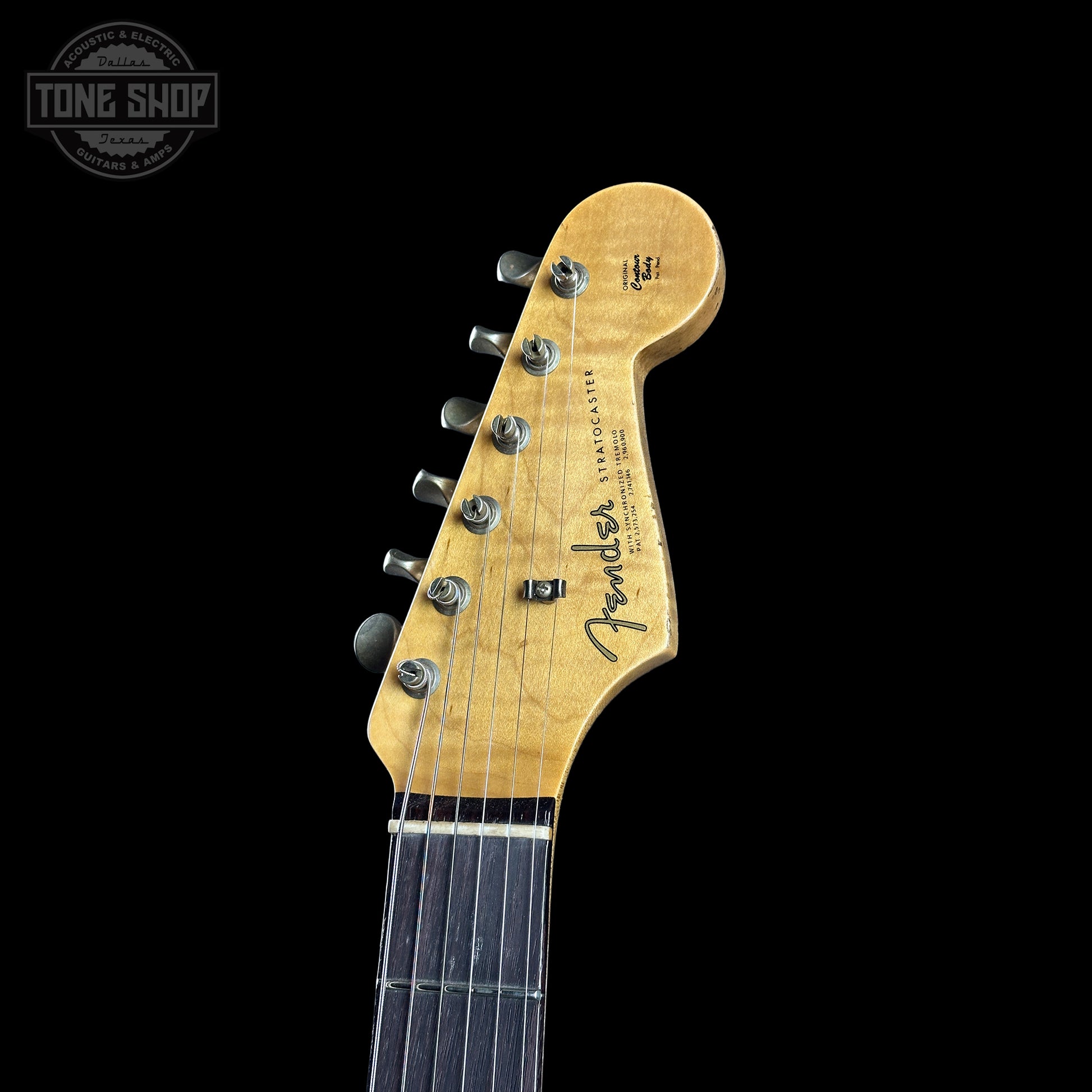 Fender guitar headstock on a black background with 'Tone Shop' logo.