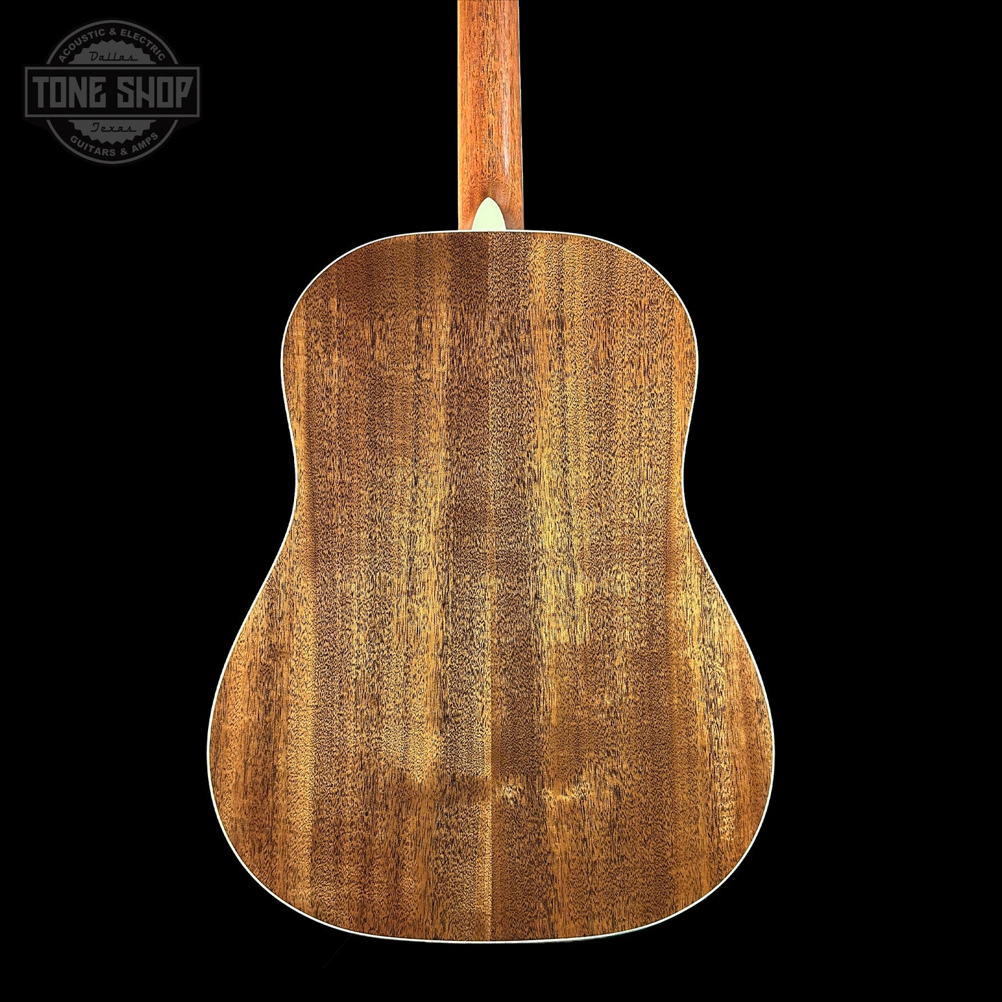 Back view of a wooden acoustic guitar with 'Tone Shop' logo.