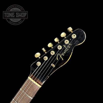 Front of headstock of Fender Custom Shop Limited Edition Reverse '60 Tele Custom Heavy Relic Aged Black Over 3 Color Sunburst.