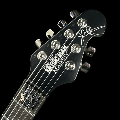 Front of headstock of Used Ernie Ball Music Man John Petrucci Black.
