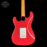 Red electric guitar with a white pickguard on a black background, featuring 'Tone Shop' logo.