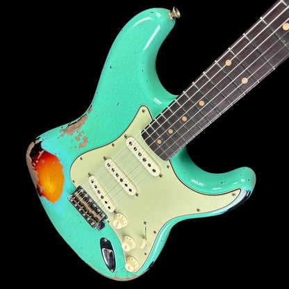 Front angle of Fender Custom Shop Limited Edition '62 Strat Heavy Relic Faded Aged Sea Foam Green Over 3 Color Sunburst.
