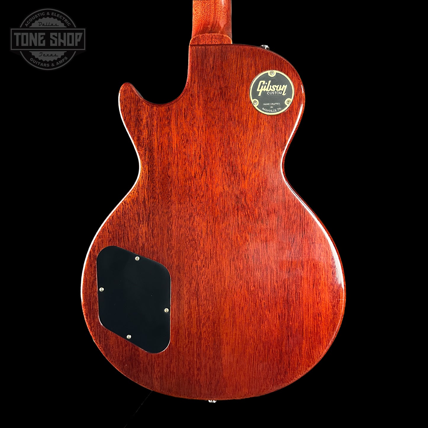 Back view of a Gibson electric guitar with a visible brand logo on a black background.