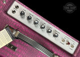 Guitar amplifier head with control knobs on a pink case, featuring the Tone Shop logo.