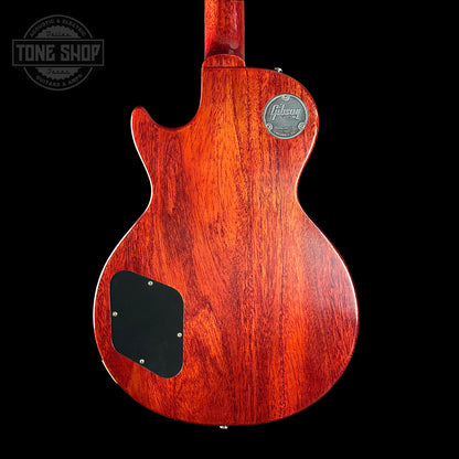 Back view of a red electric guitar with a visible brand logo on a black background.