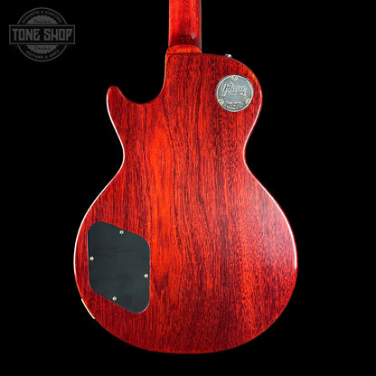 Red electric guitar body with a visible brand logo on a black background