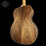 Wooden guitar body with 'Tone Shop' logo in the corner