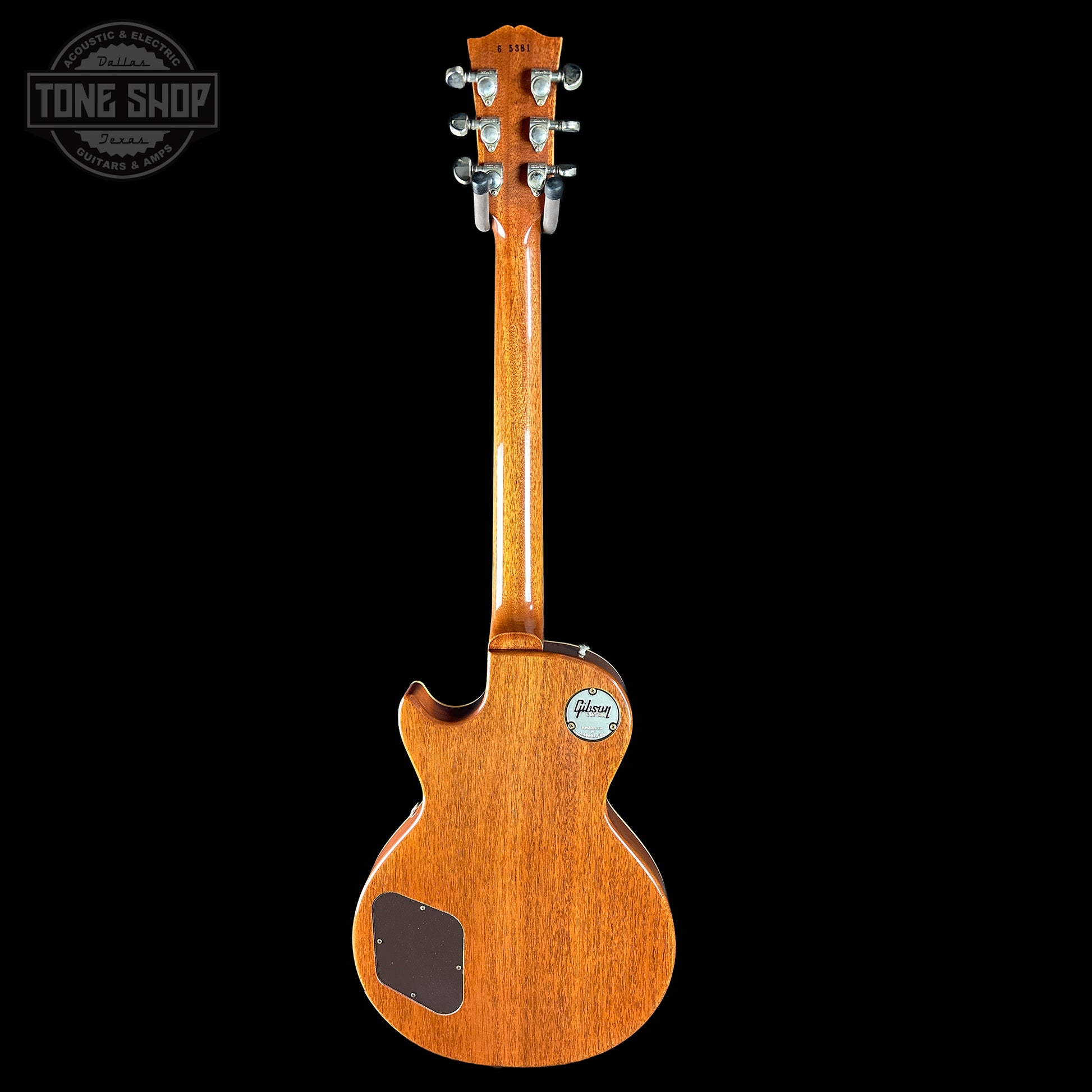 Wooden guitar with a visible brand logo on a black background