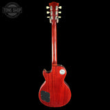 Red electric guitar on a black background with 'Tone Shop' logo.