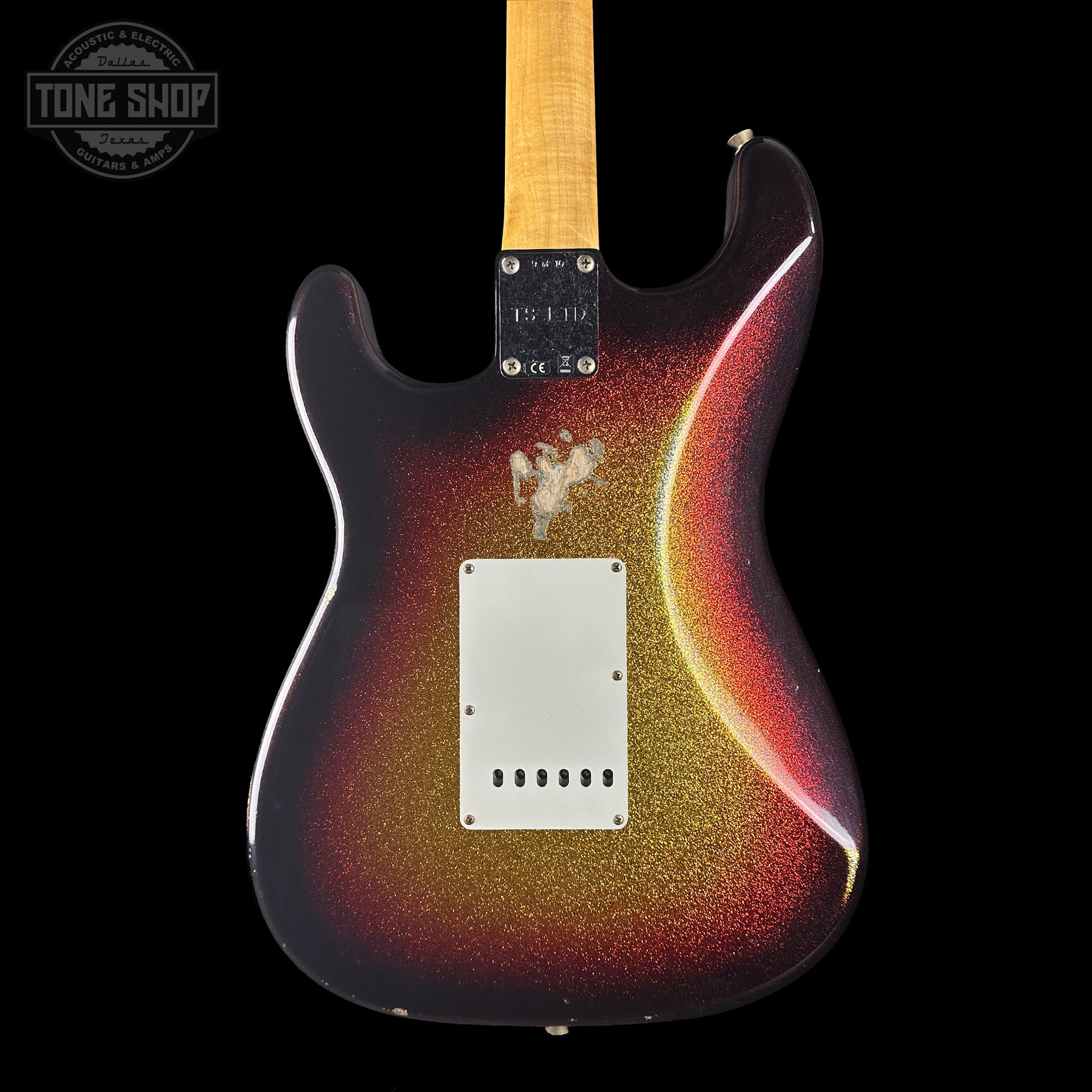 Glossy electric guitar with a sunburst finish on a black background, featuring the Tone Shop logo.