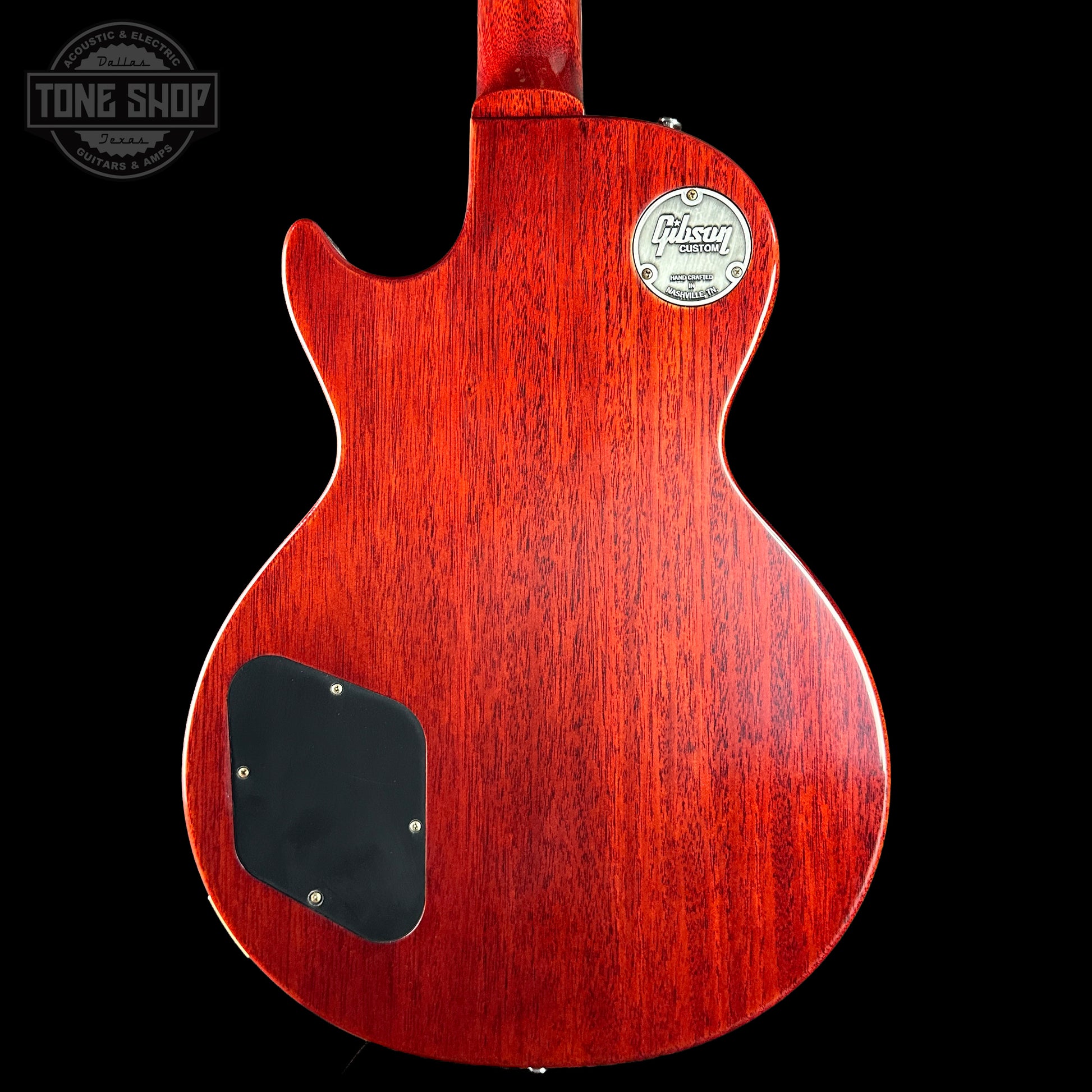 Red electric guitar with a visible brand logo on a black background