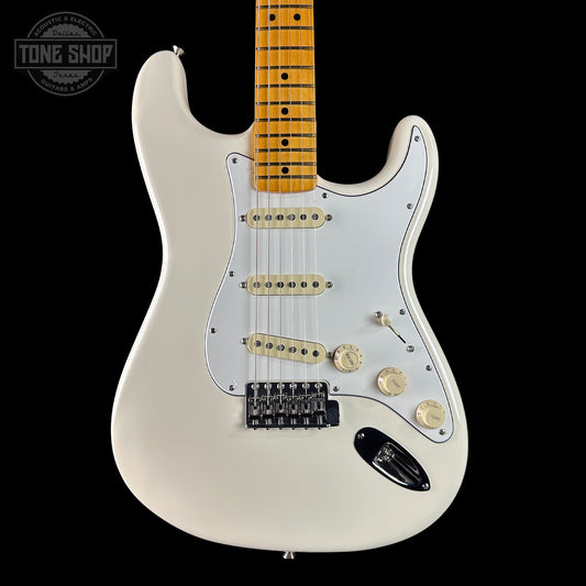 White electric guitar with a maple neck on a black background, featuring the Tone Shop logo.