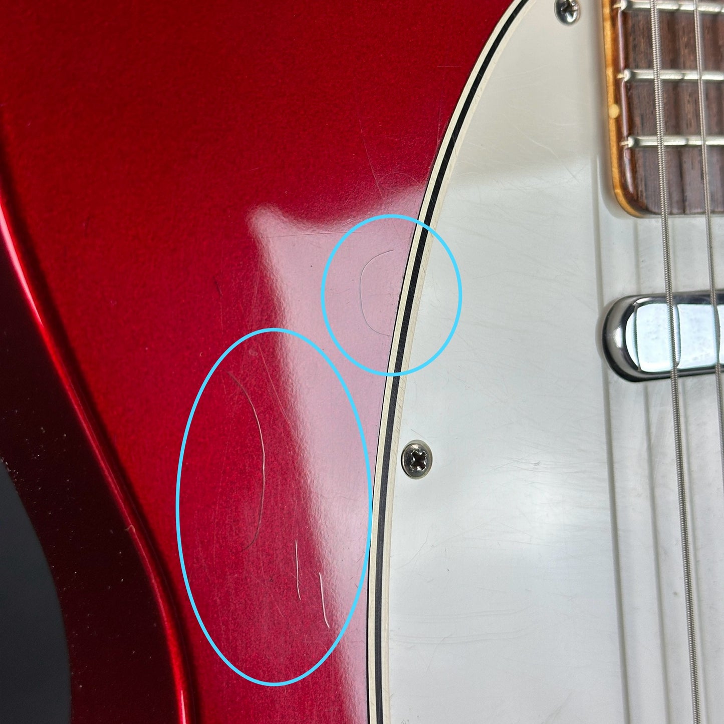 Scratches near pickguard of Used 2000 Fender Custom Shop 63 Telecaster NOS Candy Apple Red.