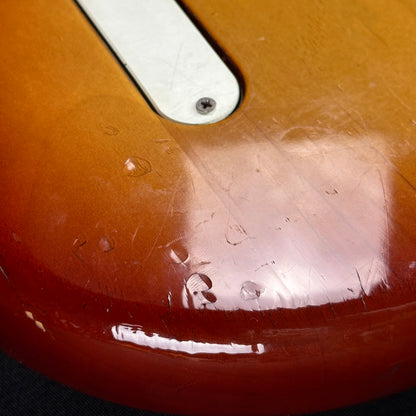 Damage on bottom edge of Used 1983 Fender Elite Precision Bass II Sienna Burst.